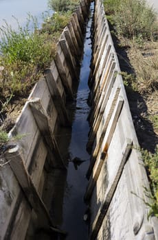 Salt farm Irrigation Ditch, made with wooden boards.