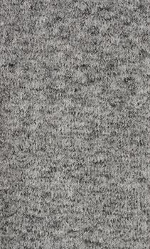 Fine grey knitted fabric as an abstract background texture