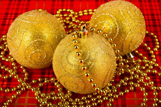 Gold Christmas balls on a red background