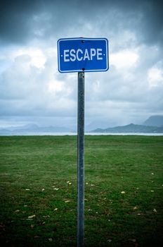 Conceptual Image Of A Grungy Escape Sign In An Empty Wilderness