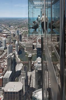 CHICAGO, USA - JUNE 3, 2010:  Tourist in The Ledge, glass balconies in 103th floor of the Sears Tower in Chicago