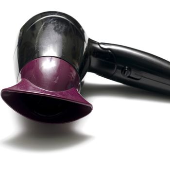 old used electric hair dryer on a white background