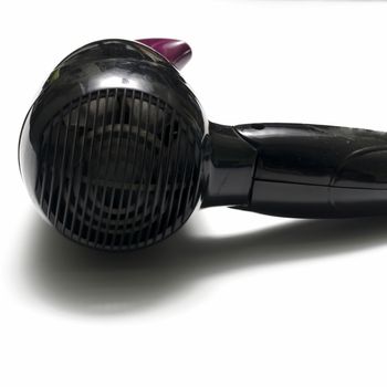 old used electric hair dryer on a white background