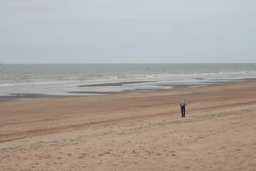 Waves with white crests inundate the sand beach