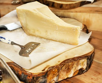 Parmesan cheese on a wooden plate