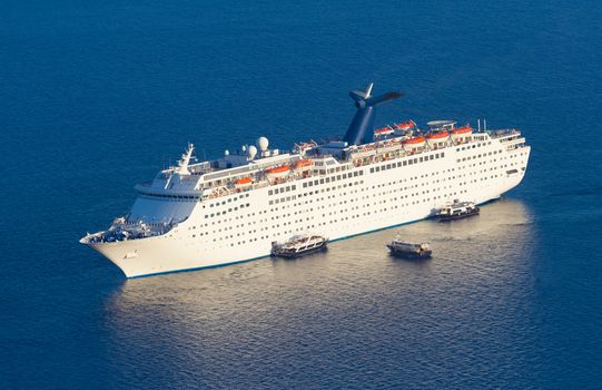 Luxury cruise ship sailing around Santorini island, Aegean sea in Greece.