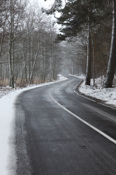 Snowy road in winter landscape