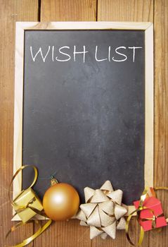 Wish list background with space handwritten on a chalkboard with christmas decorations