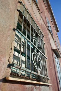 window with iron grating to be maintained