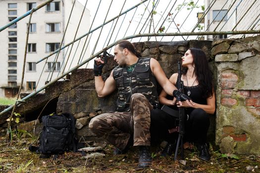 War, conflict. Guy with girl on a battlefield