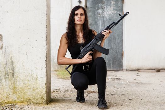 War, conflict. Female soldier with a gun