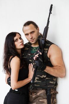 War, conflict. Guy with girl on a battlefield