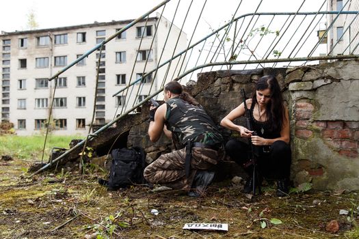 War, conflict. Guy with girl on a battlefield