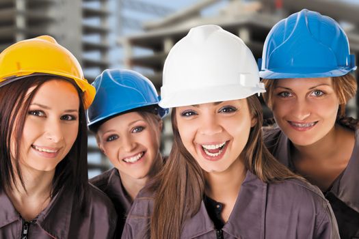 Smiling women construction team with protective clothing. Isolated with work path.