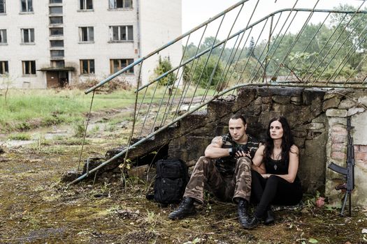 War, conflict. Guy with girl on a battlefield