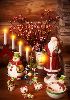 Figures of porcelain snowmen, Father Frost and a fir-tree with toys on the shelf