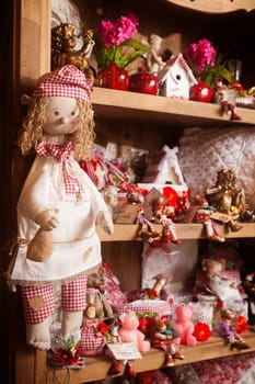 Wooden shelf in the shop with a set of rag dolls