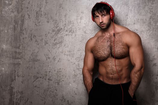 Bodybuilder. Man with red headset