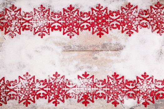 Snowflakes border on grunge wooden background. Winter holidays concept