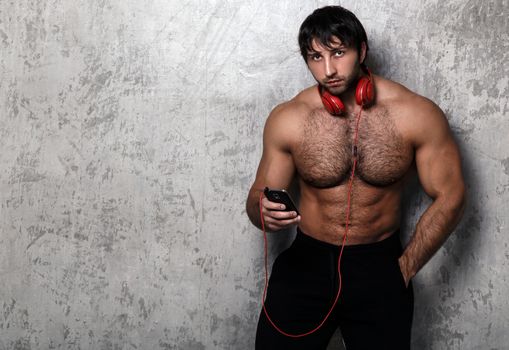 Bodybuilder. Man with red headset