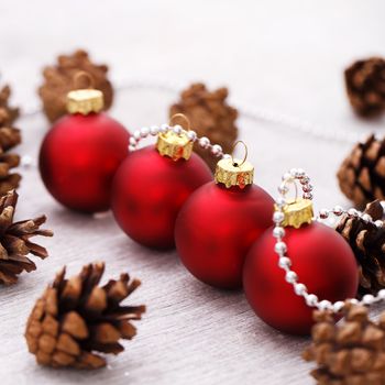 Pinecones with decorative Christmas balls on the floor