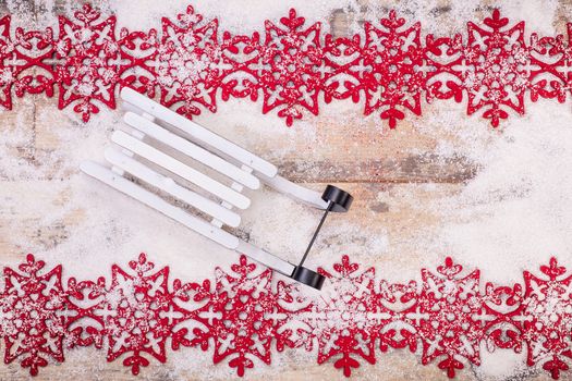 Christmas decoration over snow. Wooden background