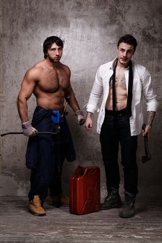 Strong and crazy men with construction tools