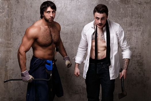 Strong and crazy men with construction tools