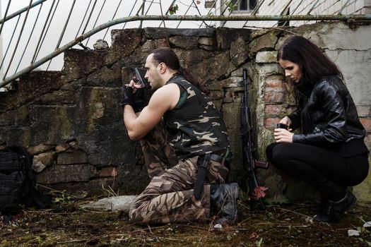 War, conflict. Guy with girl on a battlefield