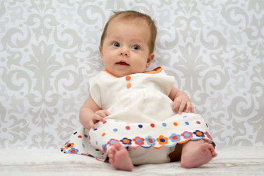 Little baby girl in  dress in a white dress