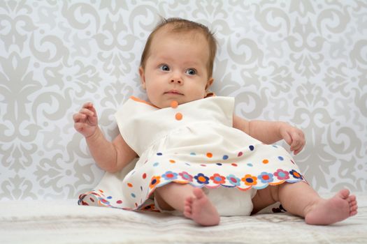 Little baby girl in  dress in a white dress