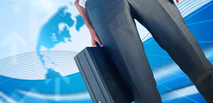 Businessman holding briefcase against global business graphic in blue