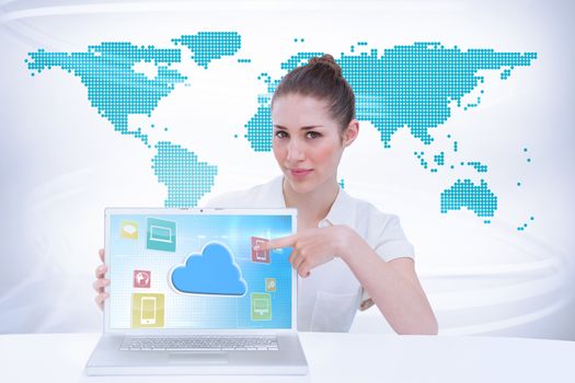 Businesswoman showing a laptop against green world map on white background