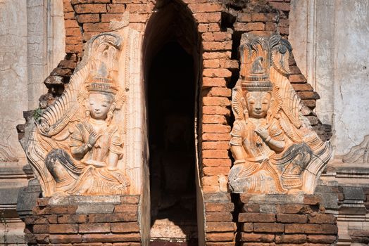 Entrance and  guardians in ruins of ancient Burmese Buddhist pagodas in the village of Indein on Inlay Lake, Myanmar (Burma).