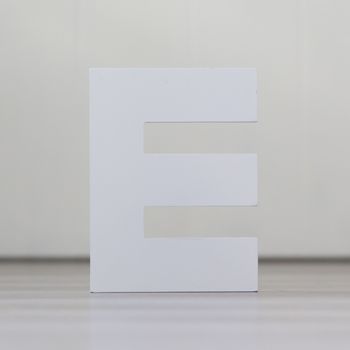 One letter on the wooden floor - E