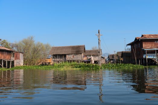 Traditional stilts wooden and bamboo houses of Intha people in water on Inle lake, Myanmar (Burma) 