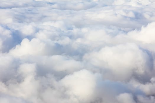 Soft clouds over view from airplane flying
