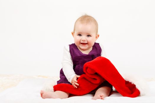 Child girl with Christmas santa hat on white background