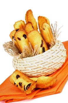 Arrangement of Biscuit Raisin Cookies in Wicker Bowl on Orange Napkin closeup on White background