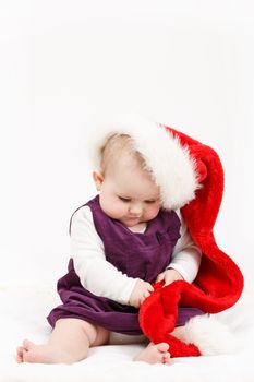 Child girl with Christmas santa hat on white background