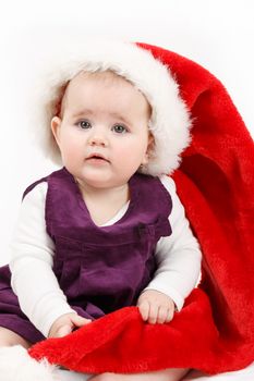 Child girl with Christmas santa hat on white background