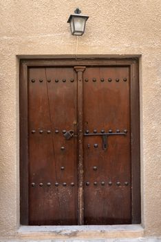 Antique old wooden door with metal bolt and lock