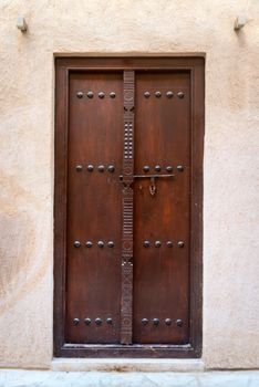 Antique small wooden door with metal bolt 