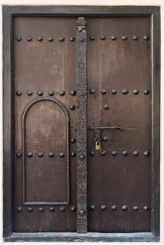 Antique double wooden door with metal bolt and lock