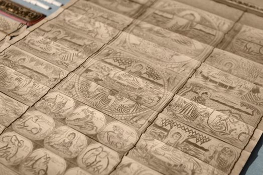 Traditional asian Buddhist images carving on bamboo wooden slips.
