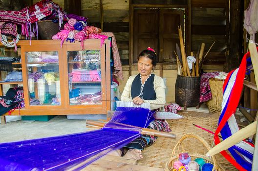 Women Pa-Ka-Geh-Yor (Karen Sgaw) in Tribal dress was weaving. Ethnic group spread north of Thailand. Image is taken at Doi Inthanon, Chiang Mai,Thailand.