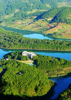 Fantastic landscape of eco lake for travel at Dalat, Viet Nam, fresh atmosphere, villa among forest, impression shape of hill and mountain from high view, wonderful vacation for ecotourism in spring 