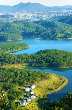 Fantastic landscape of eco lake for travel at Dalat, Viet Nam, fresh atmosphere, villa among forest, impression shape of hill and mountain from high view, wonderful vacation for ecotourism in spring 