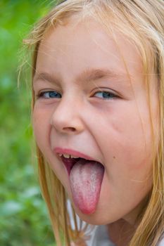 Portrait of cute girl with put out tongue