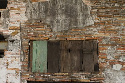 Severe corrosion of the mud-brick hut weathered facades,